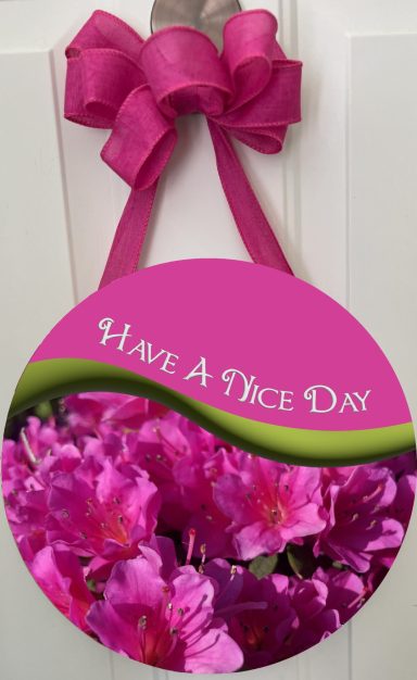 12-inch round sign with pink azaleas and the text "Have A Nice Day" on a pink background.