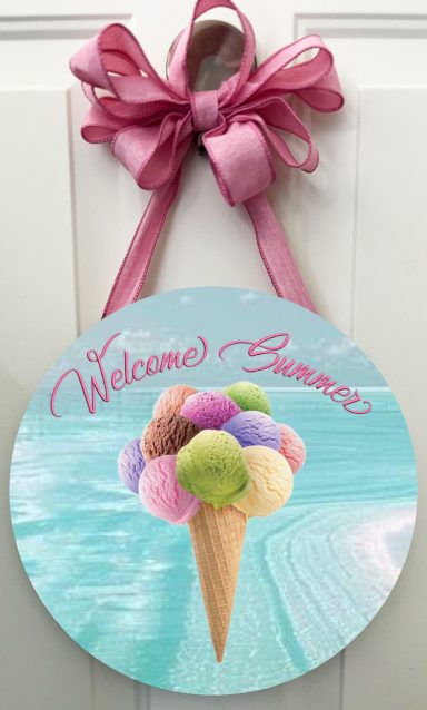 Round sign with pink bow, featuring colorful ice cream cone and "Welcome Summer" text.